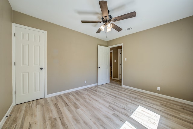 empty room featuring ceiling fan and light hardwood / wood-style floors