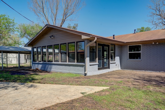 rear view of property with a sunroom