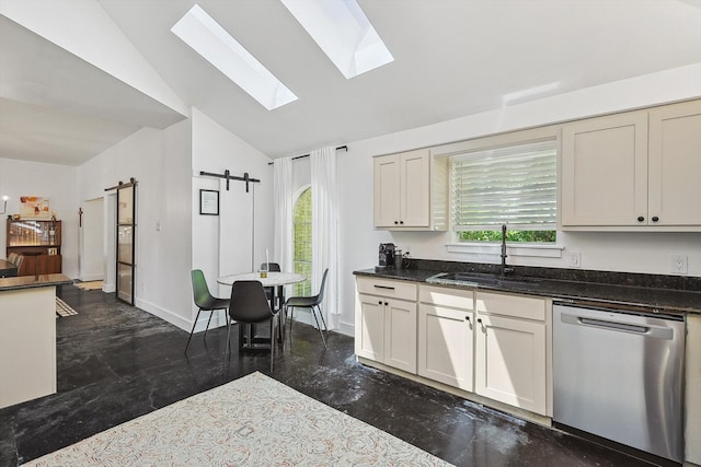 kitchen featuring a barn door, plenty of natural light, sink, and stainless steel dishwasher