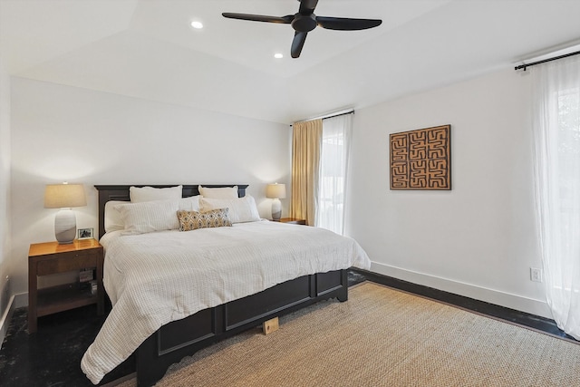 bedroom featuring a tray ceiling, dark hardwood / wood-style flooring, and ceiling fan