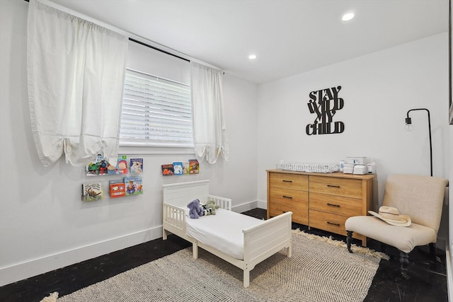 bedroom featuring a nursery area