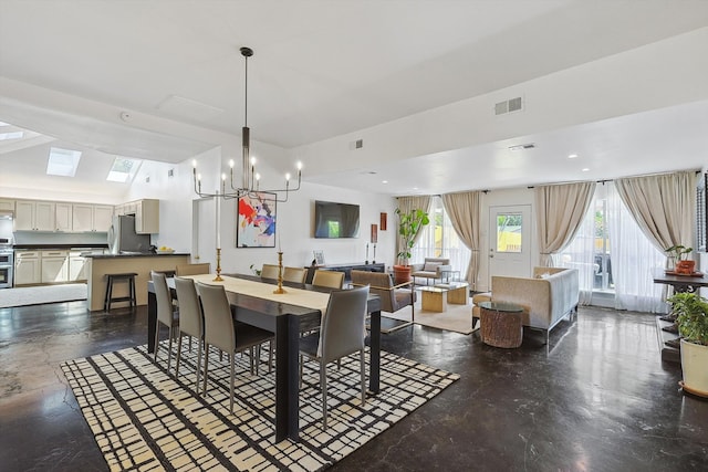 dining space featuring an inviting chandelier and lofted ceiling with skylight