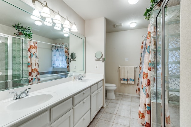 bathroom featuring toilet, tile patterned flooring, vanity, a textured ceiling, and a shower with shower curtain