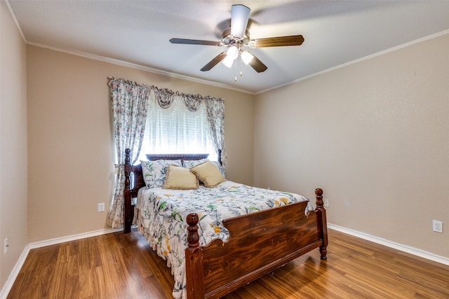 bedroom featuring ceiling fan, ornamental molding, and hardwood / wood-style floors