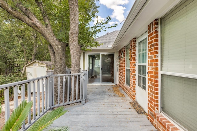 deck featuring a storage shed and an outdoor structure