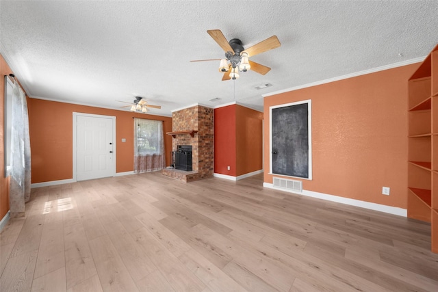 unfurnished living room featuring light wood-style floors, visible vents, and crown molding