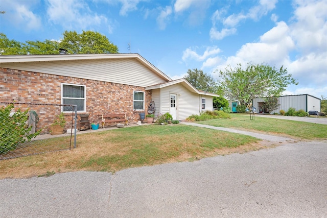 ranch-style home with brick siding and a front yard