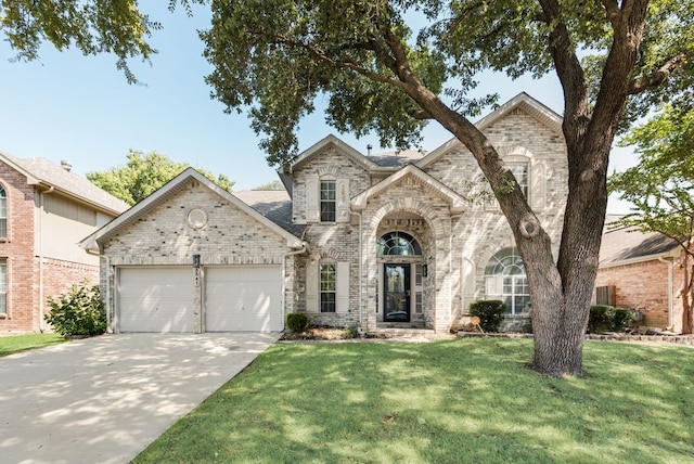 view of front of property featuring a garage and a front lawn