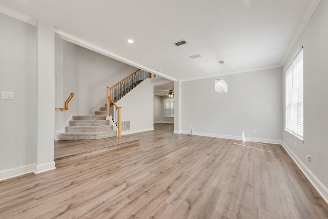 unfurnished living room featuring ceiling fan, ornamental molding, and light hardwood / wood-style flooring