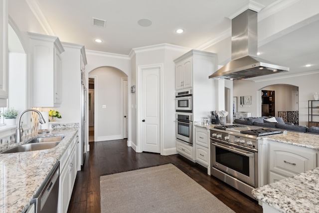 kitchen featuring stainless steel appliances, dark wood-type flooring, sink, island range hood, and white cabinetry