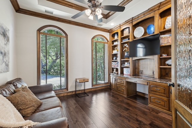 office area with ceiling fan, built in desk, dark wood-type flooring, and a wealth of natural light