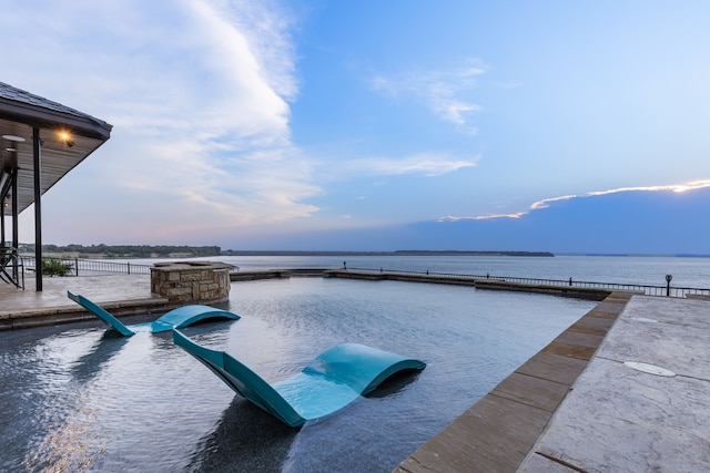 view of pool featuring a water view