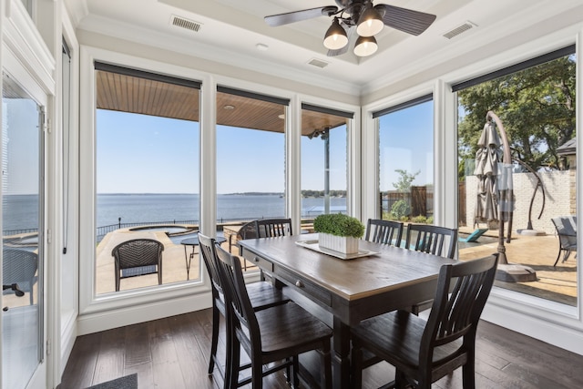 sunroom / solarium with a water view, ceiling fan, and a healthy amount of sunlight