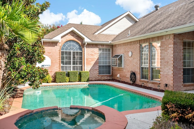 view of pool with an in ground hot tub