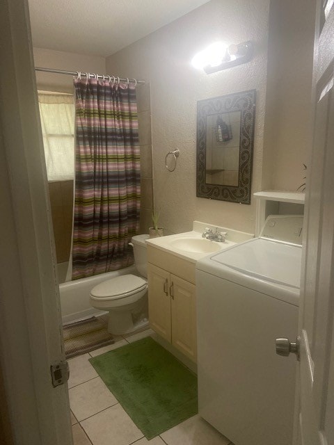 laundry area featuring cabinets, washer / dryer, and light tile patterned floors