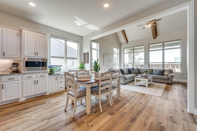 dining space featuring vaulted ceiling with beams, recessed lighting, and light wood-style floors