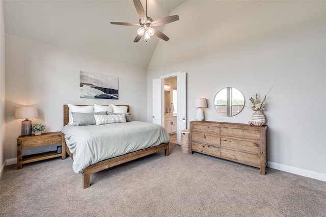 carpeted bedroom with ensuite bathroom, high vaulted ceiling, a ceiling fan, and baseboards