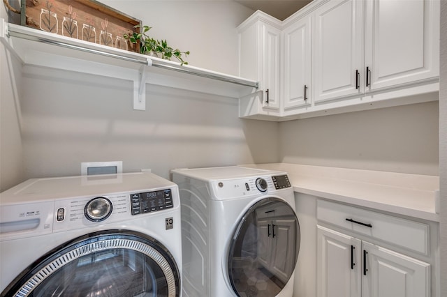 laundry room with cabinet space and washing machine and dryer