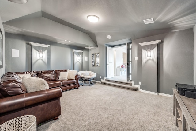 carpeted living area featuring visible vents and baseboards