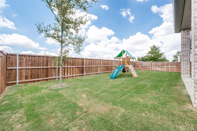 view of yard featuring a fenced backyard and a playground