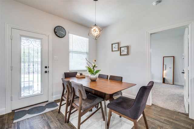 dining space with baseboards and dark wood-style flooring