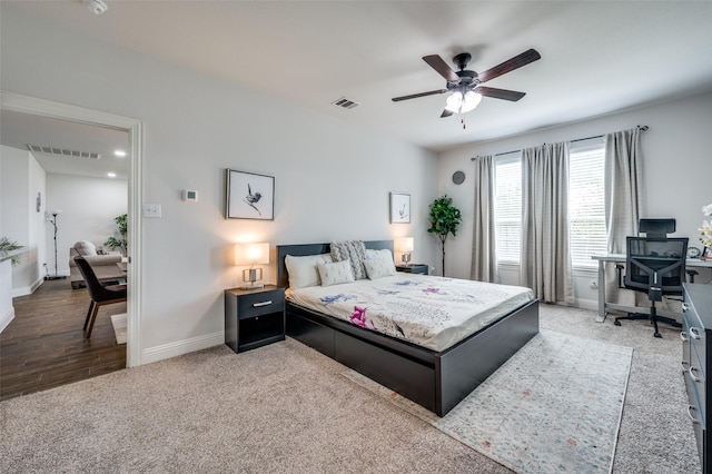 bedroom featuring carpet floors, baseboards, visible vents, and ceiling fan