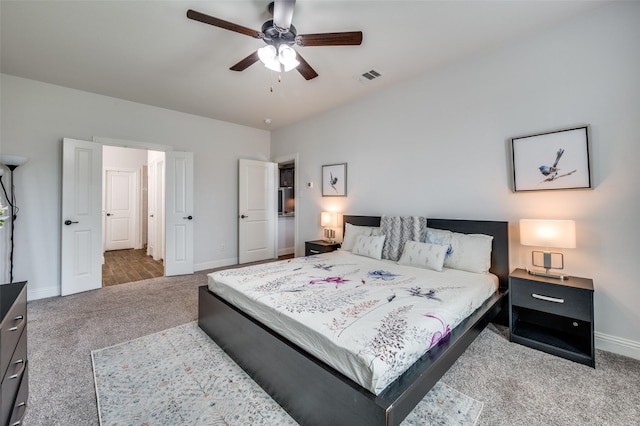 carpeted bedroom featuring baseboards, visible vents, and a ceiling fan