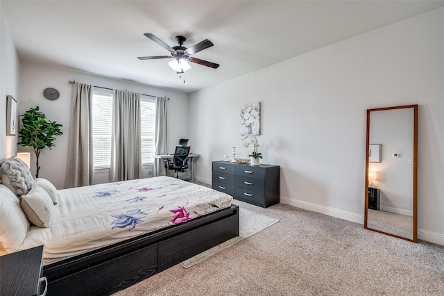 bedroom featuring baseboards, a ceiling fan, and light colored carpet