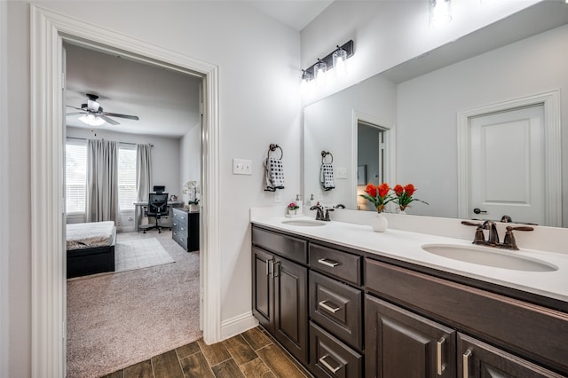 bathroom with hardwood / wood-style floors, ceiling fan, and vanity