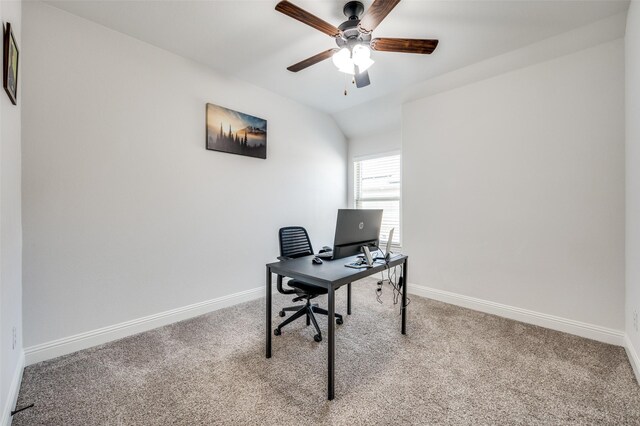 carpeted office space featuring a ceiling fan, lofted ceiling, and baseboards