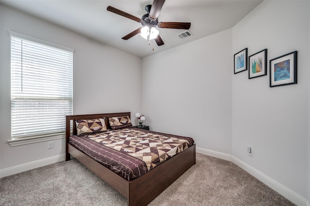 bedroom featuring a ceiling fan, carpet, visible vents, and baseboards