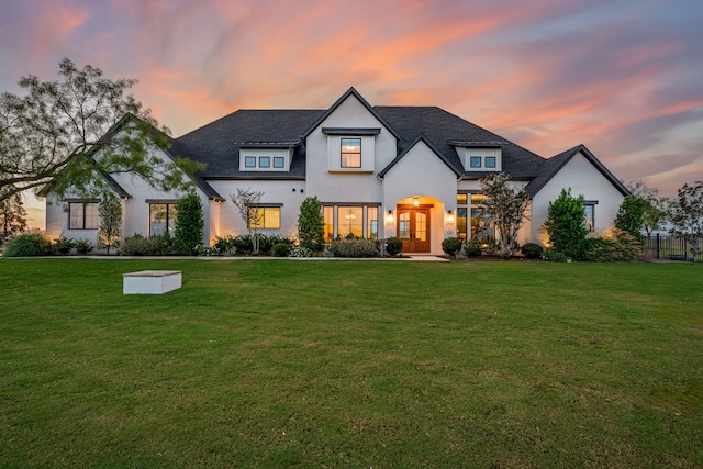 french country home featuring a yard