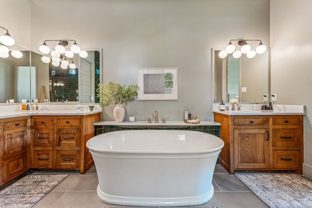 bathroom with a bathing tub, tile patterned flooring, and vanity