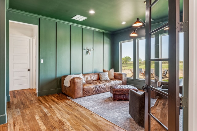 interior space with hardwood / wood-style floors and ornamental molding