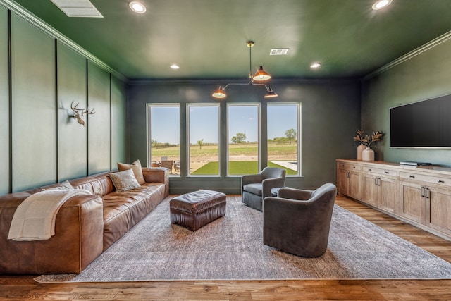 living room with hardwood / wood-style floors and crown molding