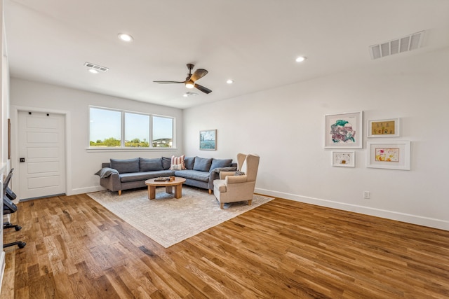 living room featuring hardwood / wood-style flooring and ceiling fan