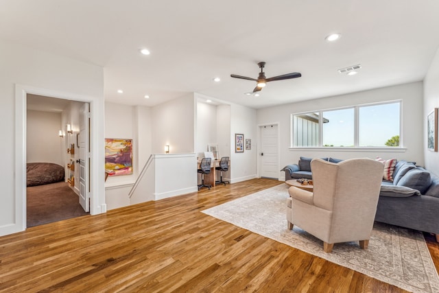 living room featuring ceiling fan and hardwood / wood-style flooring