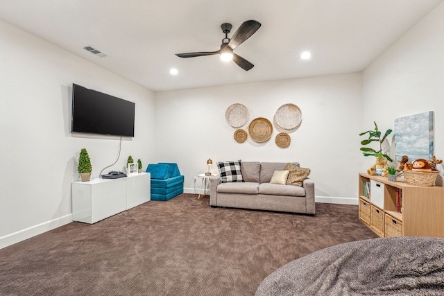 living room featuring dark colored carpet and ceiling fan