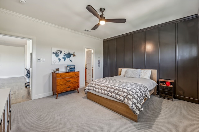 carpeted bedroom featuring ceiling fan and ornamental molding