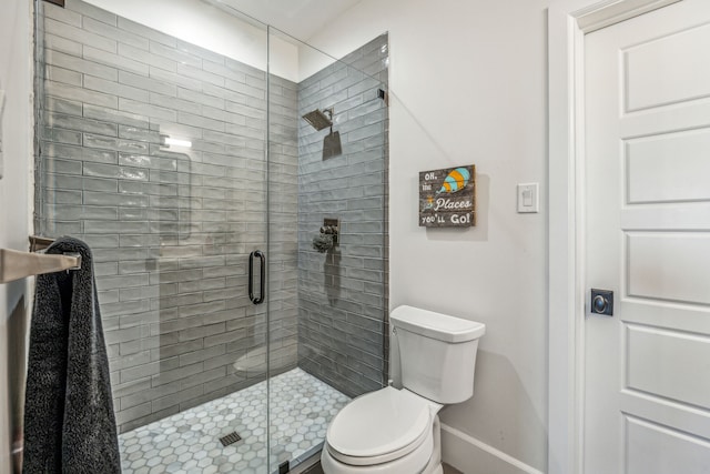 bathroom with toilet and an enclosed shower