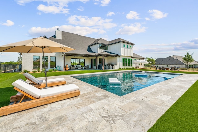 view of pool with a lawn, an outdoor living space, and a patio