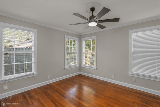 spare room featuring hardwood / wood-style floors, ceiling fan, plenty of natural light, and crown molding