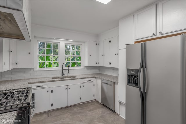 kitchen featuring light stone counters, sink, appliances with stainless steel finishes, and white cabinets