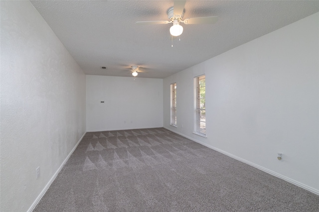 spare room featuring carpet flooring, ceiling fan, and a textured ceiling