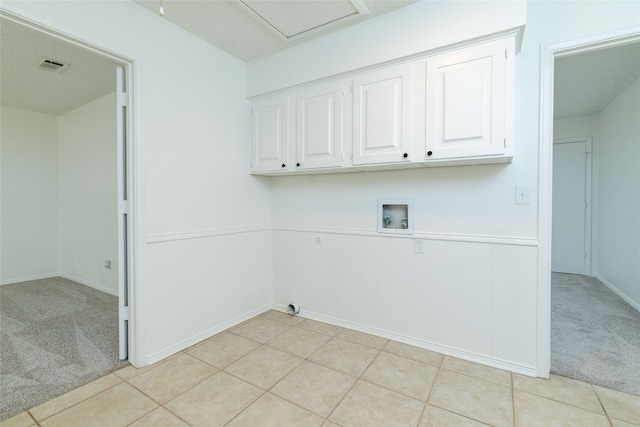 washroom with cabinets, gas dryer hookup, electric dryer hookup, light colored carpet, and washer hookup