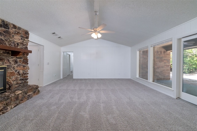 unfurnished living room featuring a fireplace, vaulted ceiling, ceiling fan, and carpet flooring