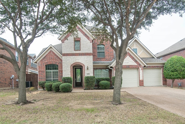 view of front of property with a garage and a front lawn