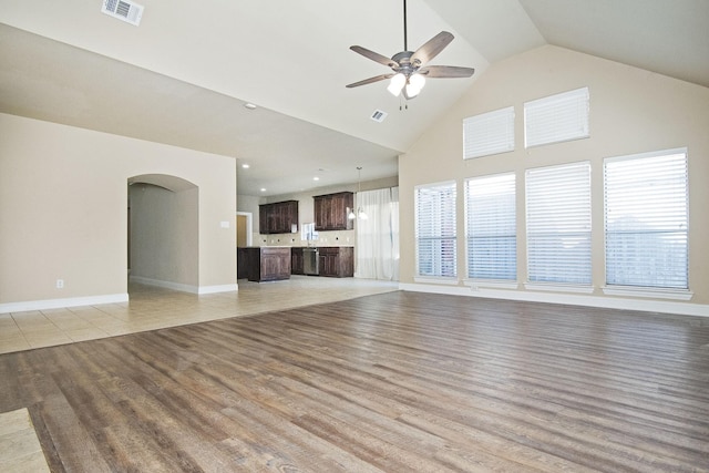 unfurnished living room with ceiling fan and light hardwood / wood-style floors