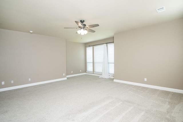 spare room with carpet floors and ceiling fan