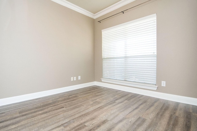 unfurnished room with crown molding and hardwood / wood-style flooring